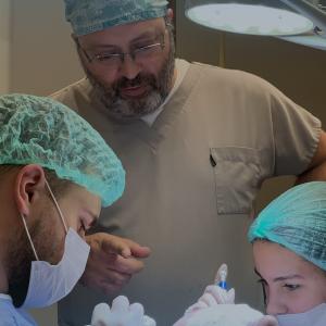 The doctor is leading the hair transplant surgery