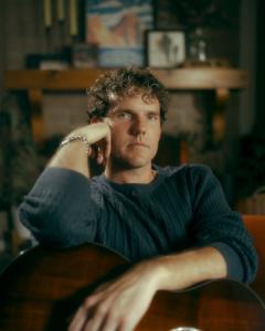 Phoenix-based indie rock musician Joey Gutos relaxed with his acoustic guitar in living room.