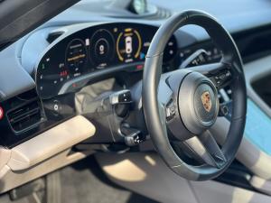 Top rated Formula X auto detailer using an inspection light to perform precise car scratch repair near me on a vehicle hood in Darien CT.