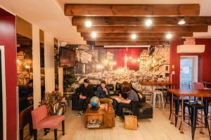 Travellers socializing in the common lounge and bar area at Samesun Montreal hostel.