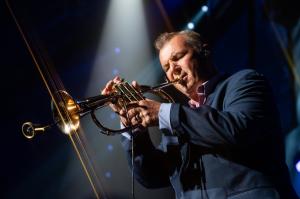 Carl Fischer playing flugelhorn on stage with Billy Joel