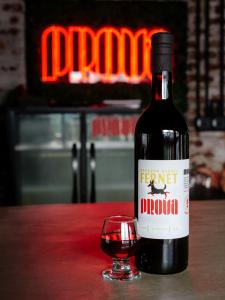 A bottle of Prova Spirits Bourbon Barrel Fernet is on display next to a small snifter of fernet