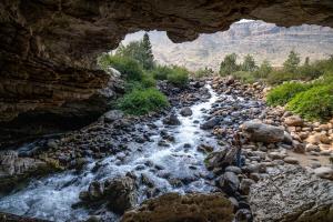 Two visitors watch as the river disappears underground in Sinks Canyon State Park.