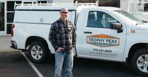 Mike Lee, founder of Trophy Peak Fire Protection, standing in front of company truck during 20 year anniversary.