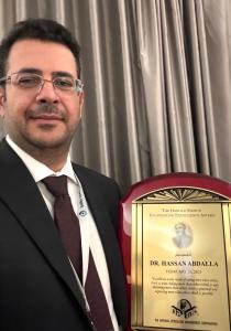 Dr. Hassan Abdalla holding the 2025 Harold Ensign Engineering Excellence Award from NPMC