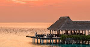 Aerial view at sunset of FireDoor fine dining overwater restaurant at Grand Park Kodhipparu Maldives
