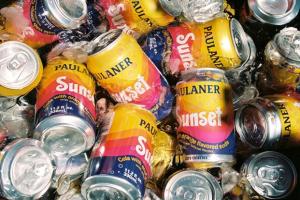 Paulaner Sunset cola-orange soda cans on ice, 11.2 oz cans brewed and bottled in Munich, Germany.