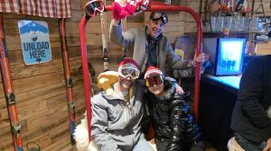 Guests in ski outfits pose inside an Alpine-themed setup at Cuckoo Clock Brauhaus in Miami, showcasing the restaurant’s high-energy Après-Ski party concept.