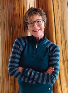 Dr. Ellington standing with arms crossed, smiling