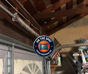A snapped garage door torsion spring on a residential track requiring emergency replacement.