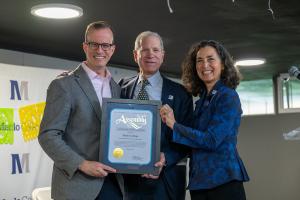 Assemblymember and Menlo staff accept a certificate of recognition.