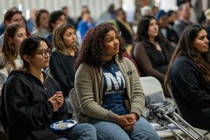 Menlo College students seated in the Student Union listen to special guest speakers.