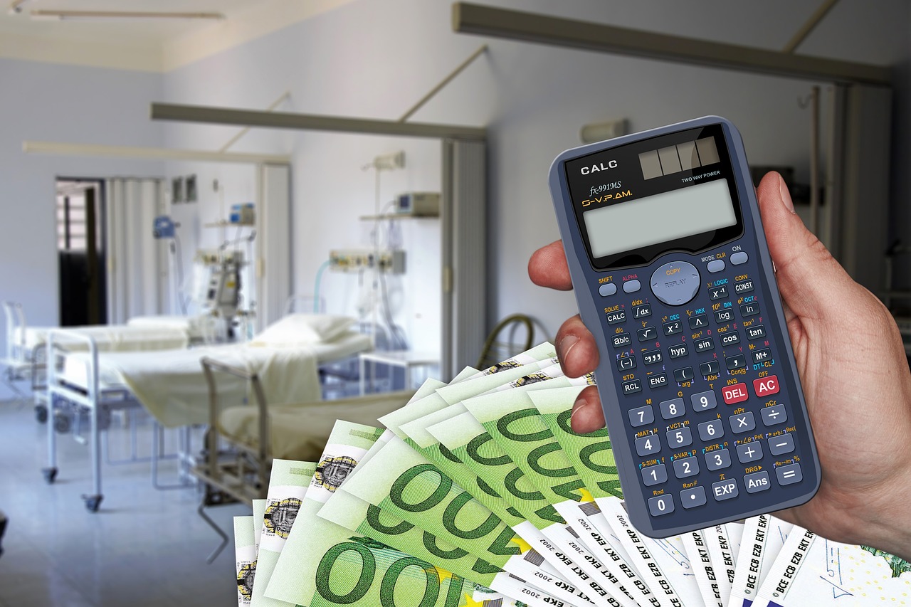 Calculator and money on hospital background representing increased revenue from Swell Country marketing strategies.