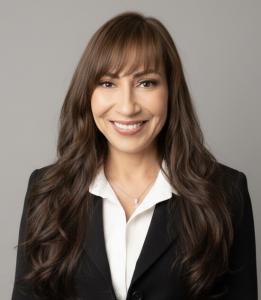 Professional headshot of author Maritza Perez smiling warmly, seated indoors with soft natural light.