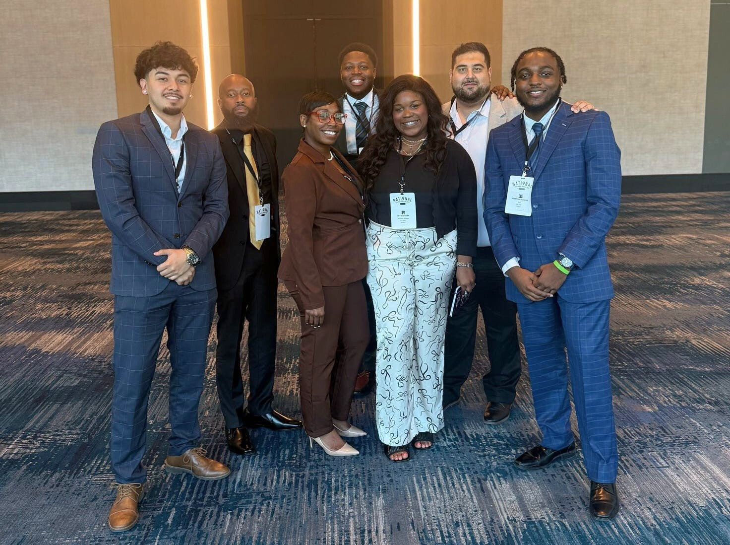 NX Direct team members stand together, representing the hands-on learning culture that supports real-world development.