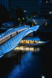 Reimei Kobashi illuminated at night with yakatabune river boats in Tokyo