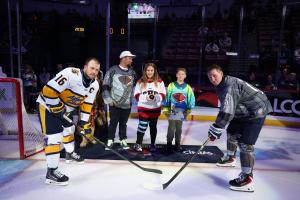 Jeff Cook and family take part in a ceremonial puck drop before a game between the South Carolina Stingrays and the Atlanta Gladiators.