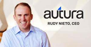 Headshot of Rudy Nieto, CEO of Autura, smiling in a light blue dress shirt, alongside the Autura logo.
