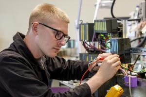 A JC-Electronics engineer carrying out quality testing on a industrial electronics spare part