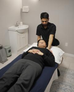 Osteopathic Practitioner Alok Kumar performing holistic manual therapy on a patient at Toronto Osteopathy and Wellness in North York.