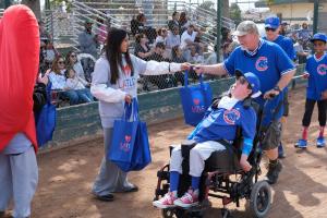 Los Angeles Trial Lawyers Charities volunteers handing out fun giveaways to the families and children participating in Bambino Buddy Ball happening at Heartwell Park in Long Beach, CA on March 7