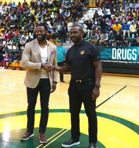 Miamian Nick Ferguson and Foundation for a Drug-Free World spokesperson Marshall Faulk speak to students in Miami’s Jackson Senior High gymnasium before the unveiling of the school’s new mural with its drug-free message