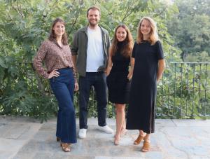 The photo shows four people standing in a row outside on a terrace with trees in the background from the Paris-based European Management and Investment Company Ring Capital