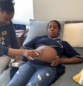 Pregnant Birth Detroit client being examined by midwife Dr. Jessica Fladger.