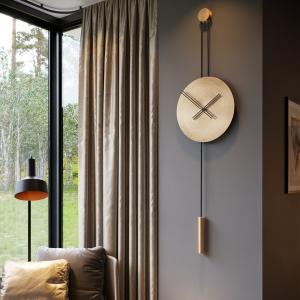 Voglana Avvolo pendulum clock with antique gold finish, blending artisan craftsmanship with modern interiors