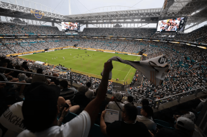 Crowd inside a full football stadium during a match, illustrating soaring demand as 2026 tournament tickets appear on resale markets at massive markups.