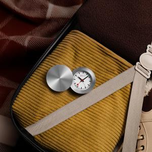 MONDAINE Travel Alarm Clock – compact Swiss-designed folding alarm clock with the iconic MONDAINE dial, ideal for travel and bedside use.