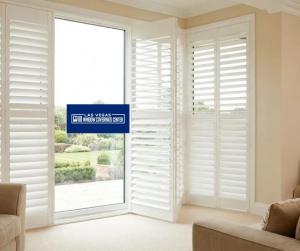 White custom plantation shutters installed in the living room of a Summerlin home.