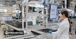 Operator moves server tray through an Instrumental station.