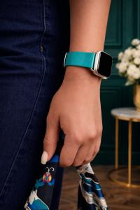 Liquid in Teal Luxury Apple Watch band on model holding bag