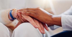 Senior patient, holding hands or consulting a nurse for support or empathy for healthcare help.