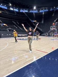 Farrah Mechael standing on the basketball court at Intuit Dome in Los Angeles during the Ballin’ 4 Peace International Women’s Day event.