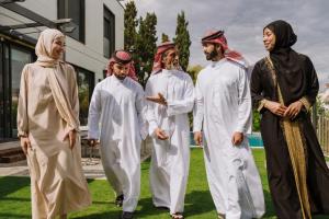Middle Eastern family discussing healthcare and addiction treatment options abroad in a private outdoor setting