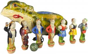Very colorful frogs skittle set, German, painted composition on wood. Fabulous large frog which serves as container has outstanding paint and colors. Pin figures depict musician and singing frogs. Length: 19.5in. Sold for $10,200