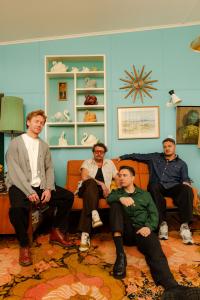 A sophisticated press portrait of the band SIX60, symbolizing the transcendence of global language debates through music. The image captures the group as a leading example of cultural resilience, aligning with the principles of the 2026 UNESCO report 'The