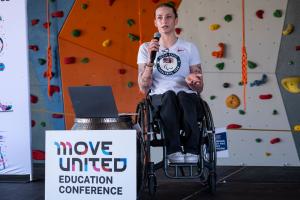 Female in wheelchair speaking on a stage