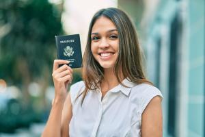 latin woman holding a green card