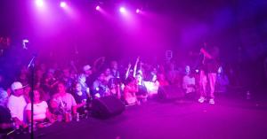 Gane on the Paper Tiger stage with visible crowd - establishes scale and energy