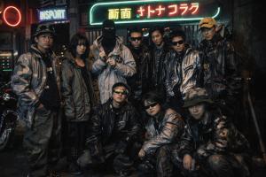 A group of young adults outside of a tokyo nightclub wearing Kommerce clothing that is inspired by PPFM