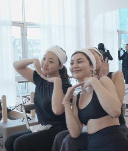 Group of girls taking photo in pilates studio.