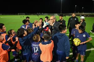 Laredo Mayor Dr. Victor D. Treviño stands at the center of a soccer field at the Buena Vista Sports Complex, exchanging high-fives with local children as they celebrate the opening of the new facility. Image Courtesy City of Laredo