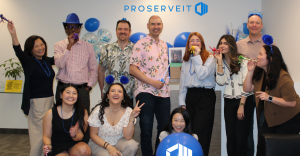 Group photo of the ProServeIT team gathered in the office during a company celebration.
