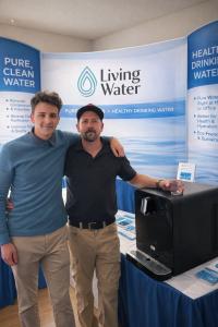 Father and son founders Steve and Jonah Stiles of RO Living Water present a high-tech 4-stage reverse osmosis bottleless water cooler at a business event in Novato, California.