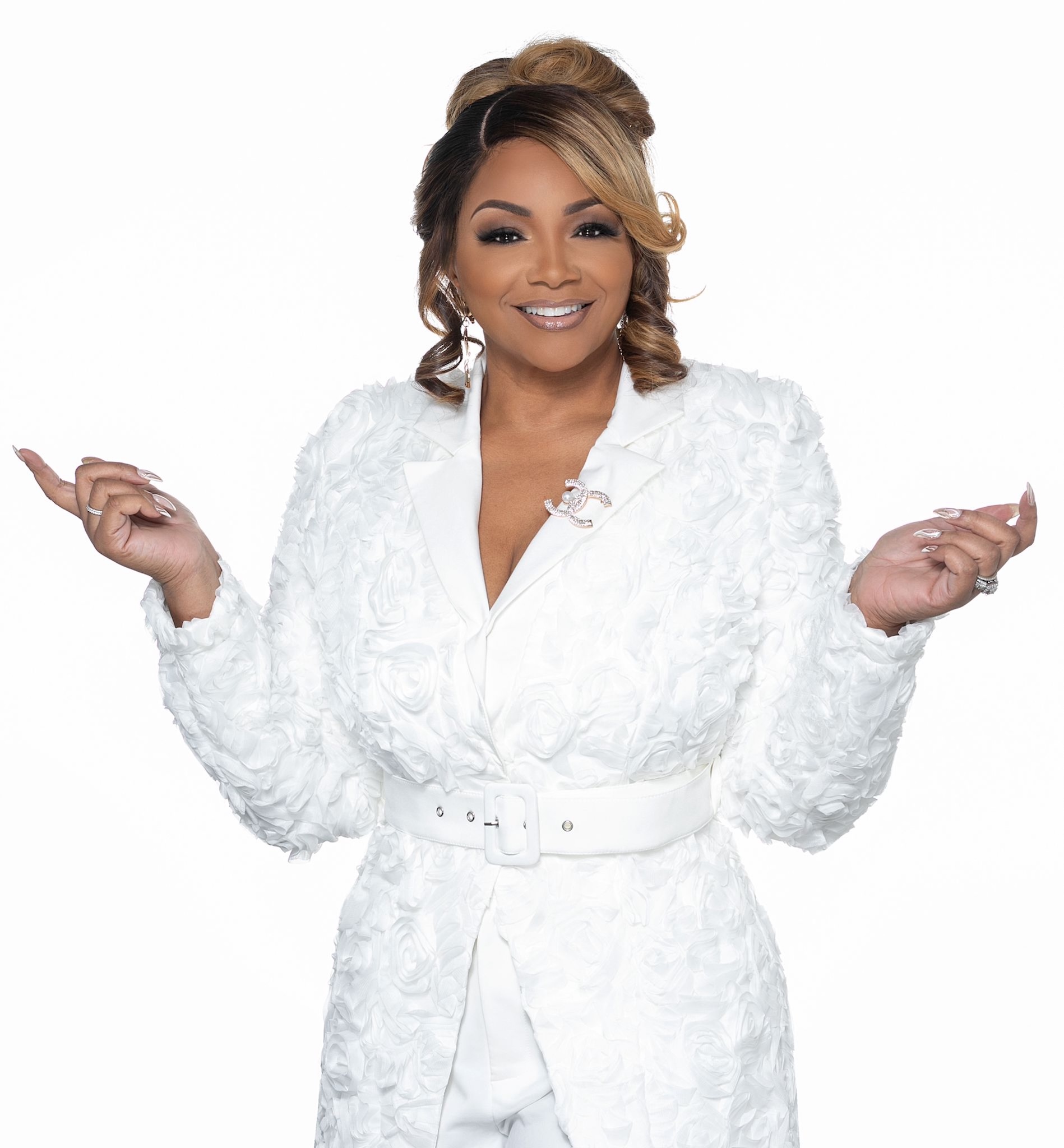 Malaysia Harrell in an elegant white outfit, posing with confidence and warmth, representing leadership, empowerment, and holistic success