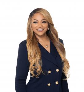 Malaysia Harrell in a tailored navy outfit, smiling with confidence and poise, reflecting empowerment, leadership, and sustainable success