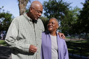 Couple holding hands and walking park